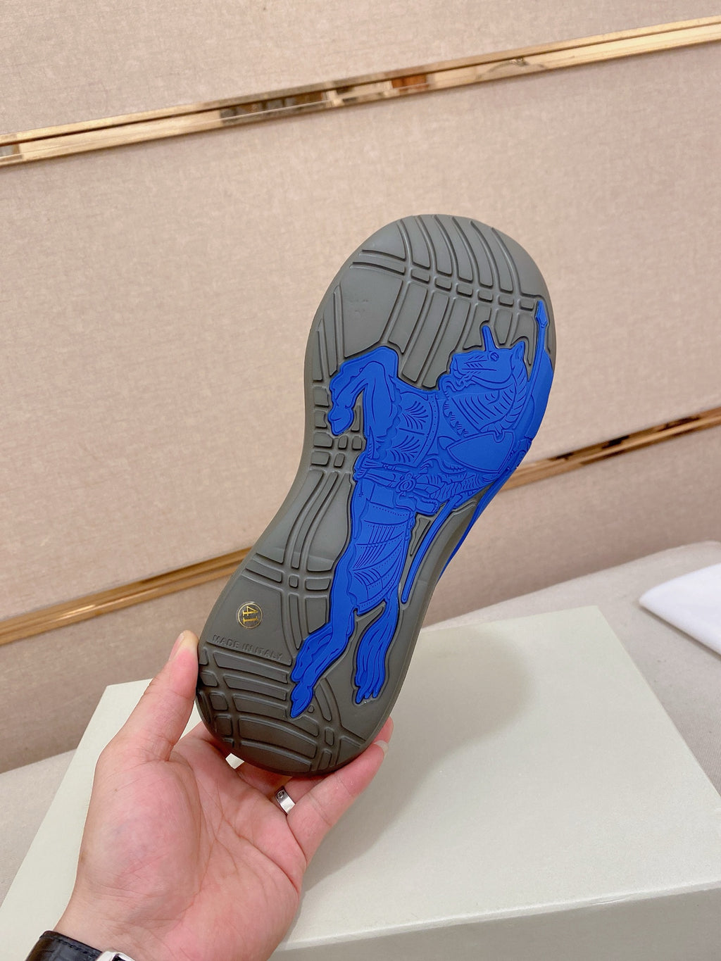 Shoe outsole with deep tread in gray and bright blue traction pattern