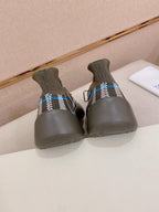 Gray knit sneakers showing heels with black-and-white plaid stripe and blue accents