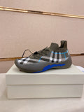 Knit sock sneakers in gray with black-and-white plaid and blue trim