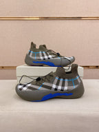 Pair of gray plaid knit sock sneakers with blue sole and lace-up design