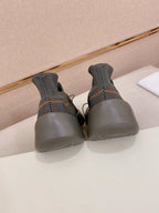Back view of gray knit sneakers with blue sole and lace-up front