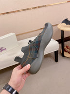 Gray knit lace-up sneakers with multicolor upper pattern and blue sole