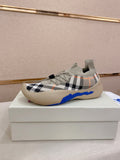 Knit sneaker with beige check pattern, blue trim, and cushioned sole