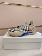 Knit sneaker with beige check pattern, blue trim, and cushioned sole