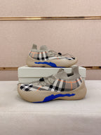 Pair of beige check knit sneakers with blue sole and lace-up front