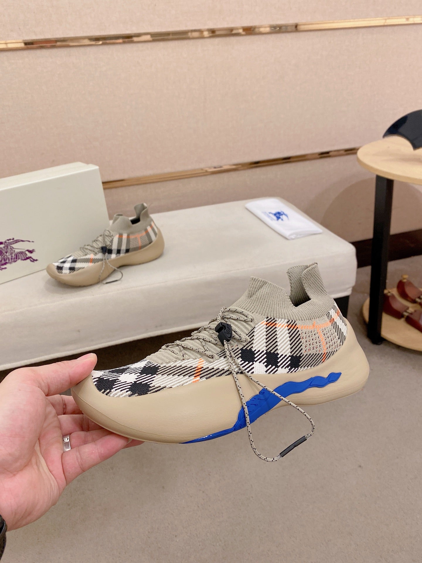 Beige check knit sneaker with blue side accent and lace-up front
