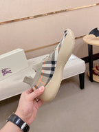 Knit sneaker upper with beige check pattern, lace-up front, and blue sole edge