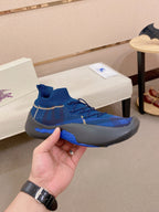 Blue knit sneaker held up, textured knit and blue sock collar detail