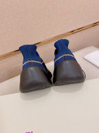 Blue knit sneakers with black heels and soles, rear view