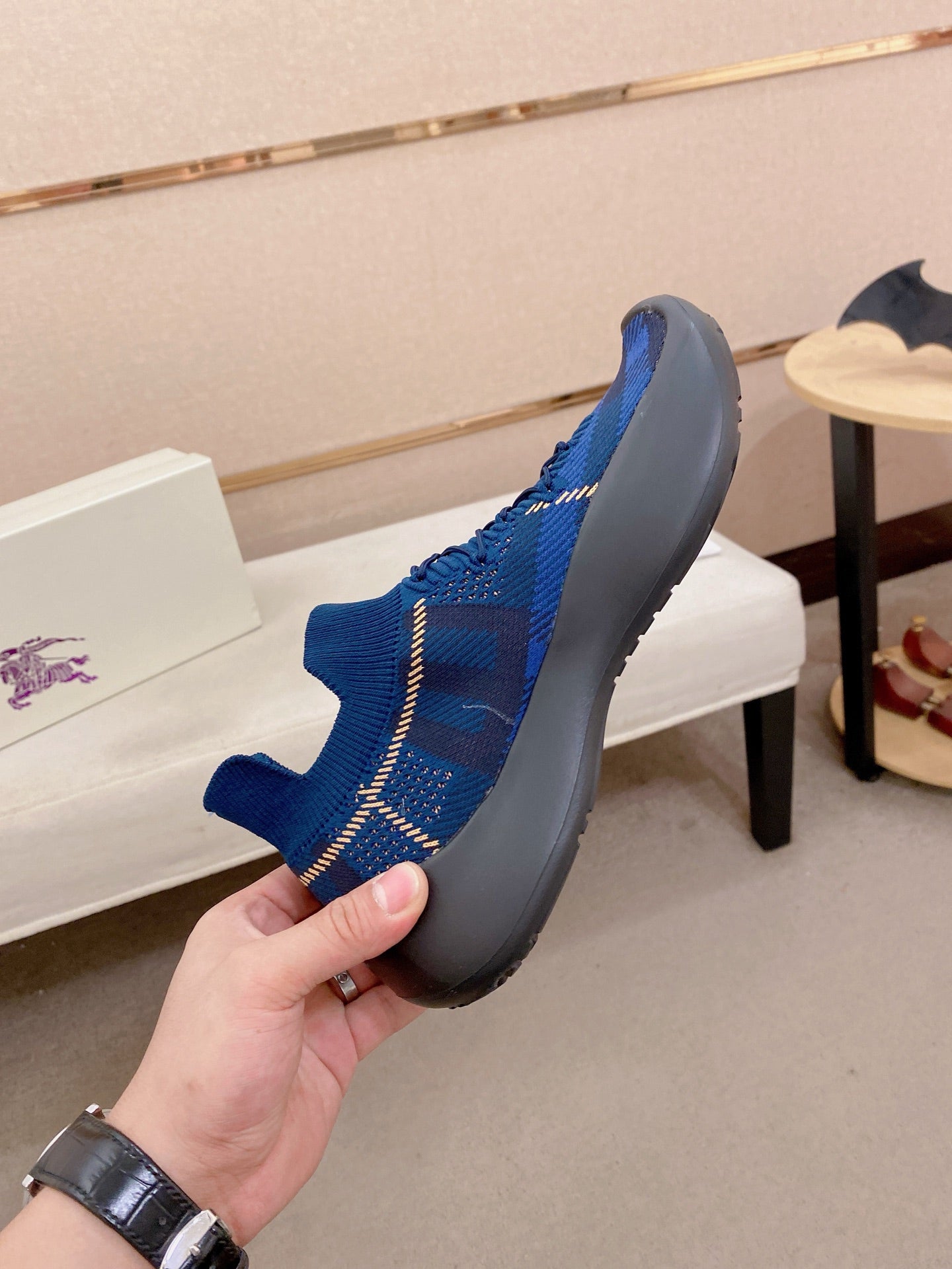 Blue knit sneaker side profile with chunky black rubber sole