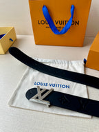 Black Louis Vuitton belt on dust bag, showing LV buckle and embossed monogram strap.