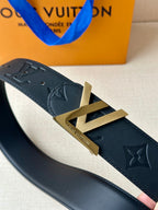 Black Louis Vuitton belt close-up showing gold-toned LV buckle and monogram embossing.