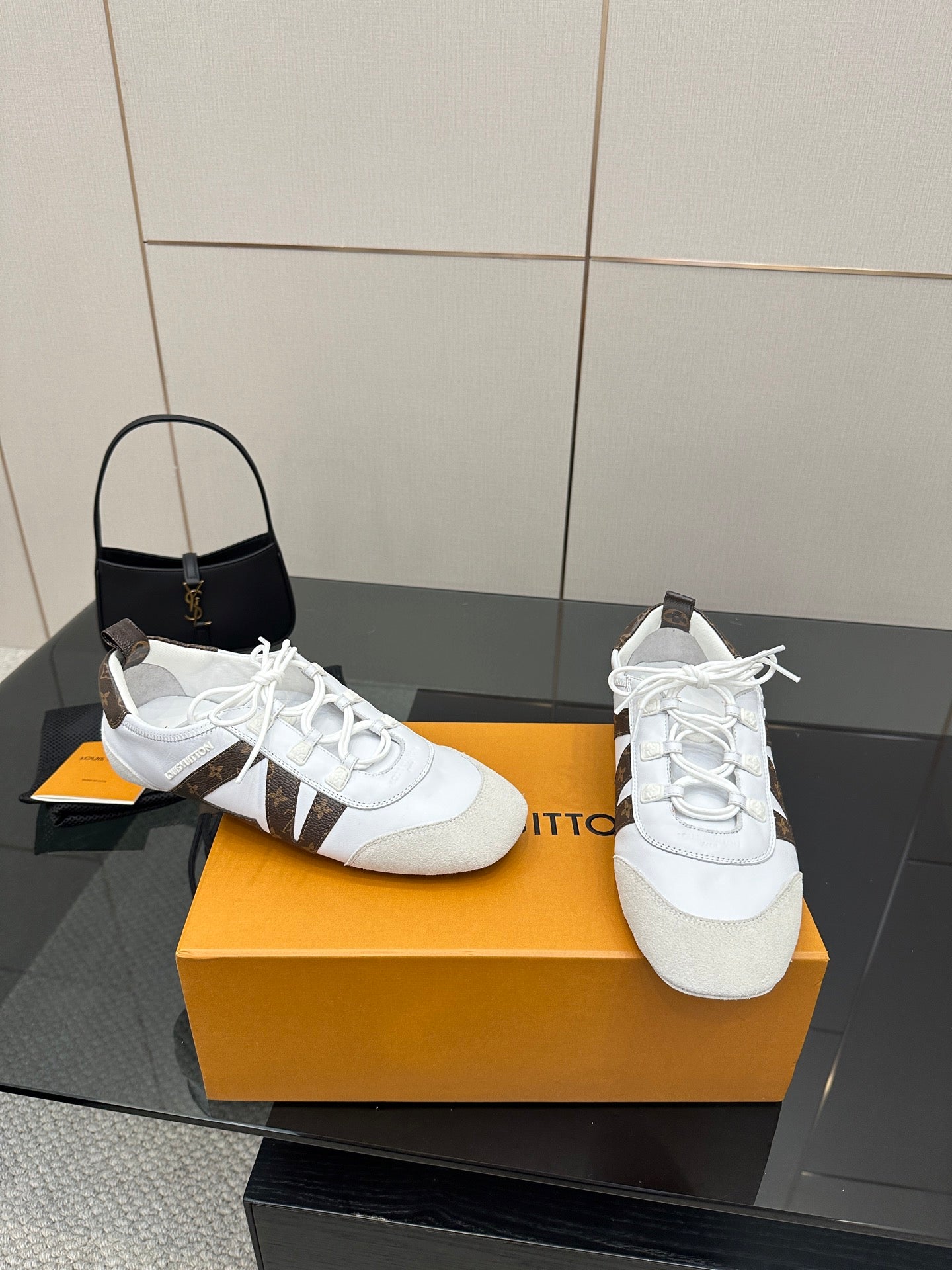 Louis Vuitton white sneakers with brown monogram accents and lace-up front