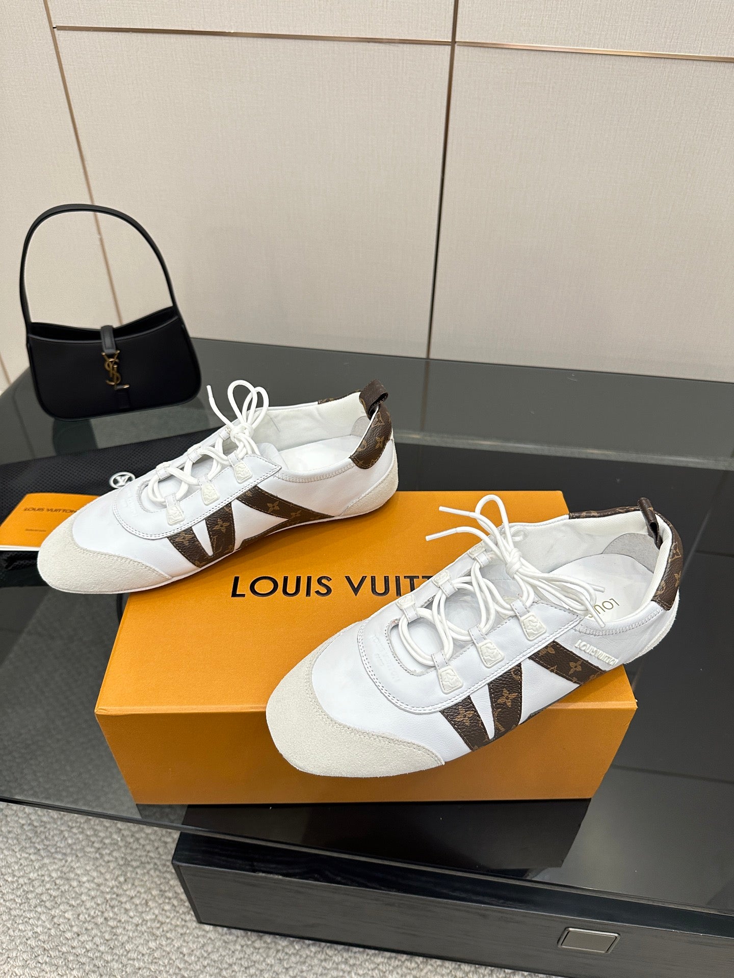 Louis Vuitton white sneakers with brown monogram strap detail and tied front laces