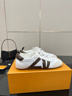 Louis Vuitton white low-top sneakers with brown monogram strip and lace-up front