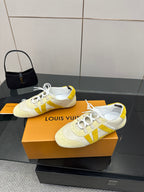 Louis Vuitton sneakers on box, cream uppers with yellow stripe, lace-up design