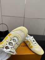 Louis Vuitton sneakers close-up, cream uppers with yellow stripe and lace eyelets