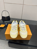 Louis Vuitton low-top sneakers, cream with yellow panels and white laces, on box