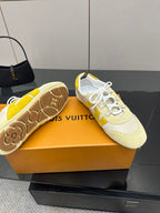 Louis Vuitton sneakers close-up, cream soles and uppers with yellow accents