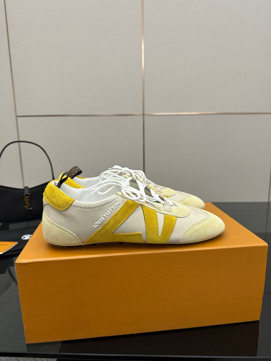 Louis Vuitton sneakers, cream with yellow V-style stripe detail and white laces