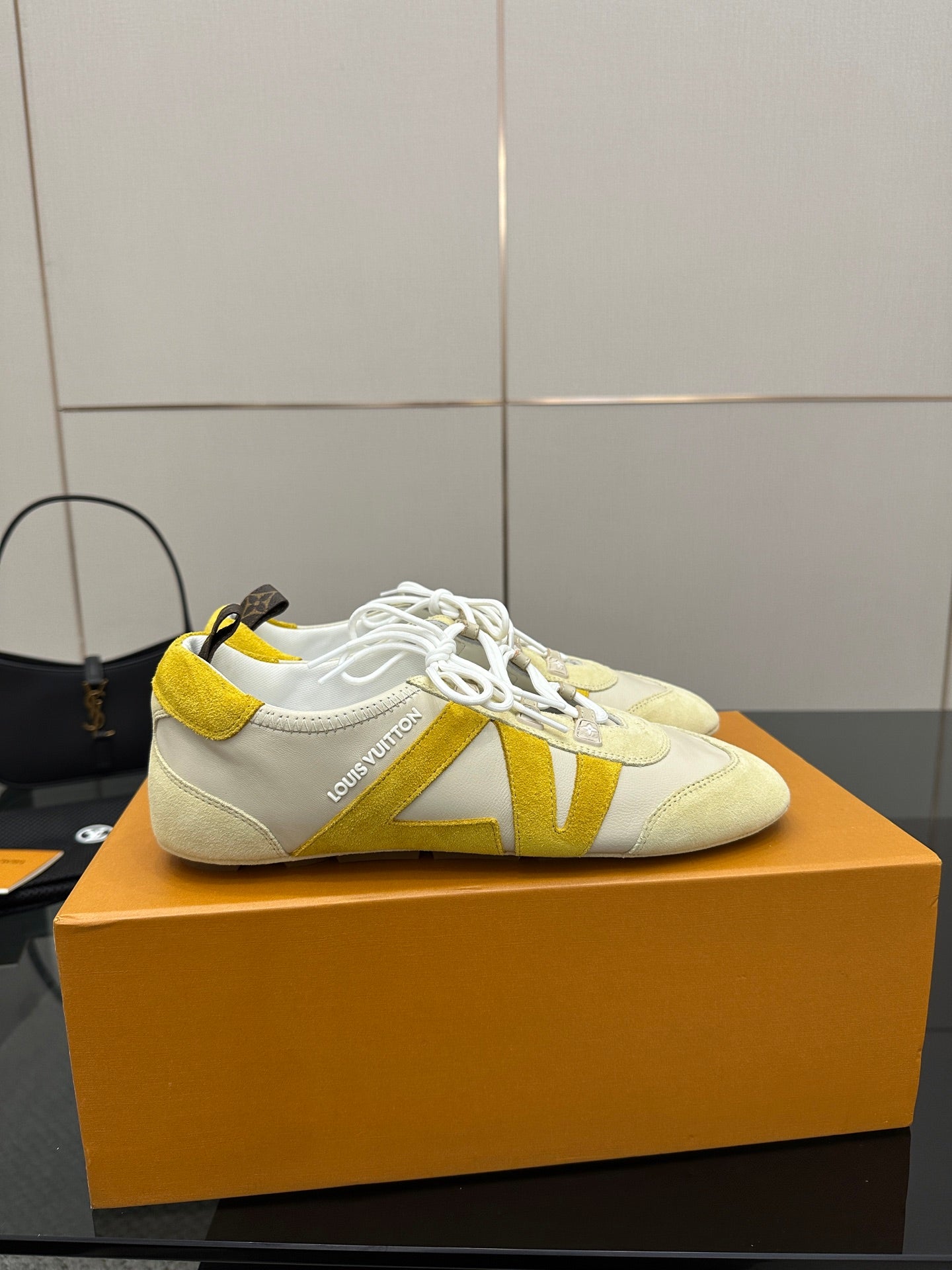 Louis Vuitton sneakers, cream with yellow V-style stripe detail and white laces
