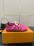 Pink lace-up sneakers with white laces and Louis Vuitton branding on side