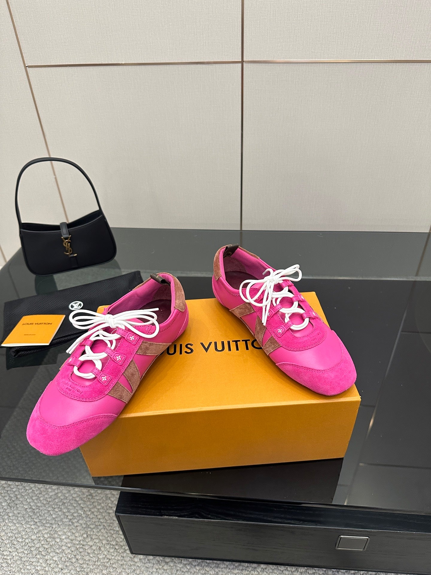 Pink low-top sneakers with white laces and patterned side panels