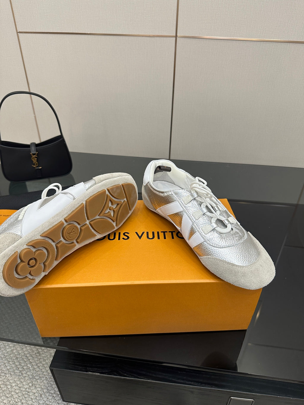 Louis Vuitton white leather sneakers with visible rubber outsole and textured pattern
