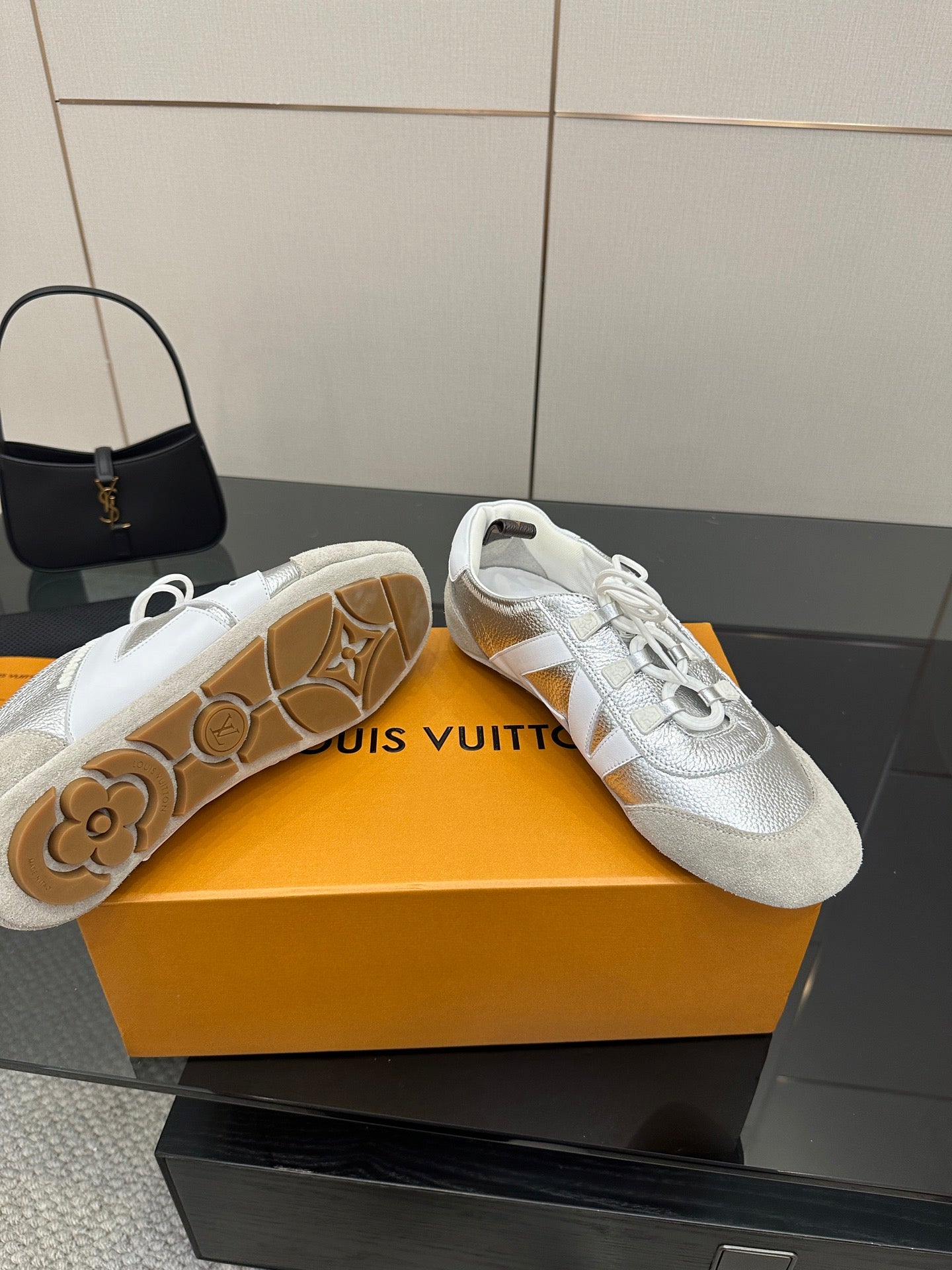 Louis Vuitton white leather sneakers with visible rubber outsole and textured pattern