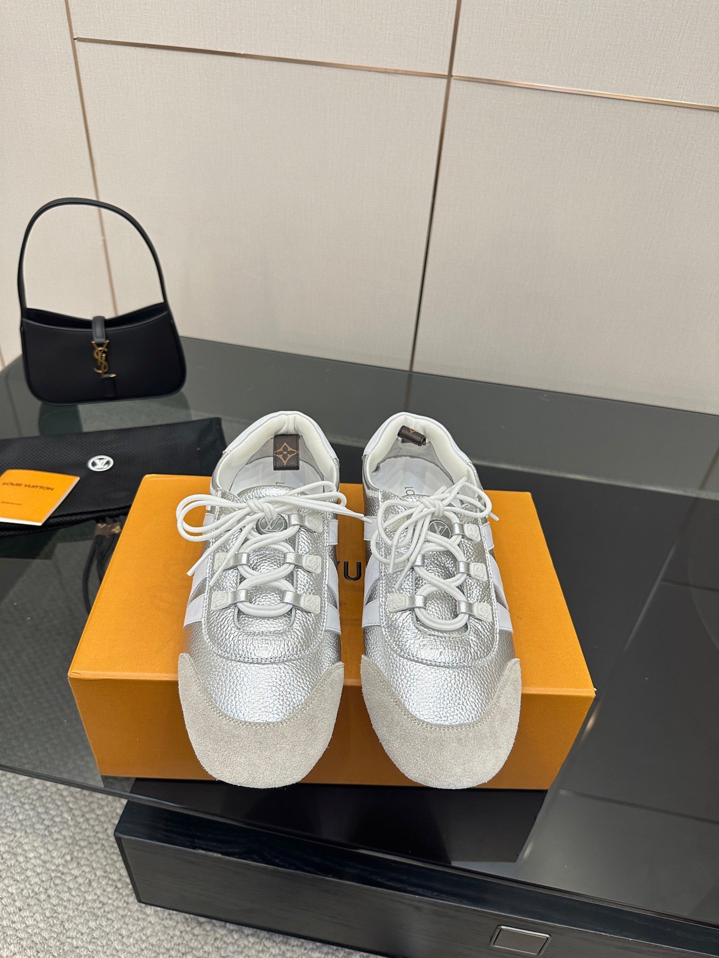 Louis Vuitton white leather low-top sneakers with white lace-up design, textured upper