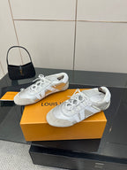 Louis Vuitton white leather lace-up sneakers, side view with textured pattern detail