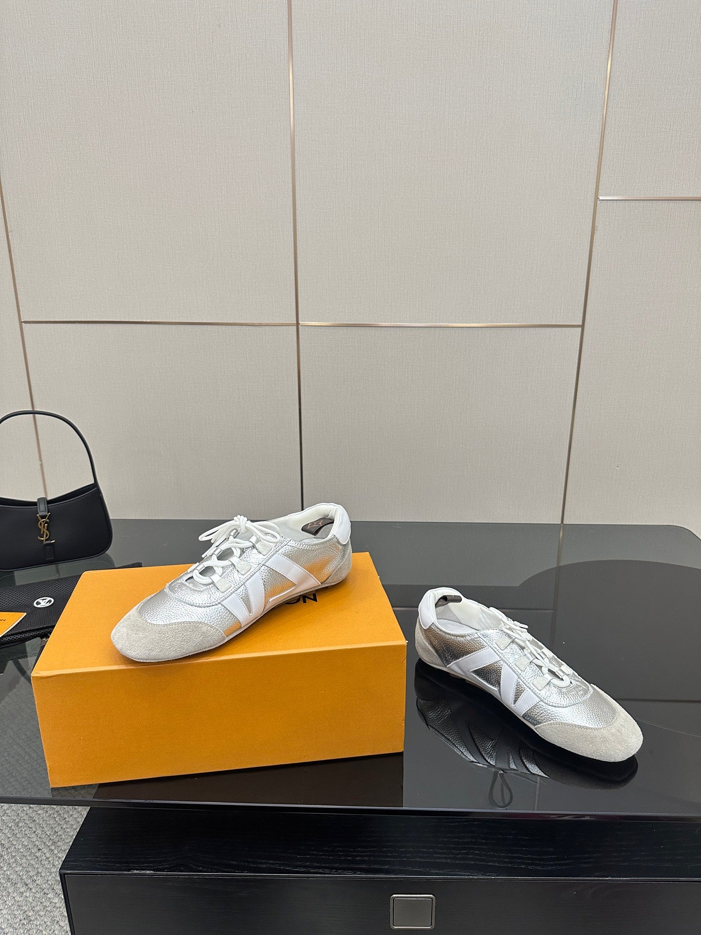 Louis Vuitton white leather sneakers, side view of lace-up uppers