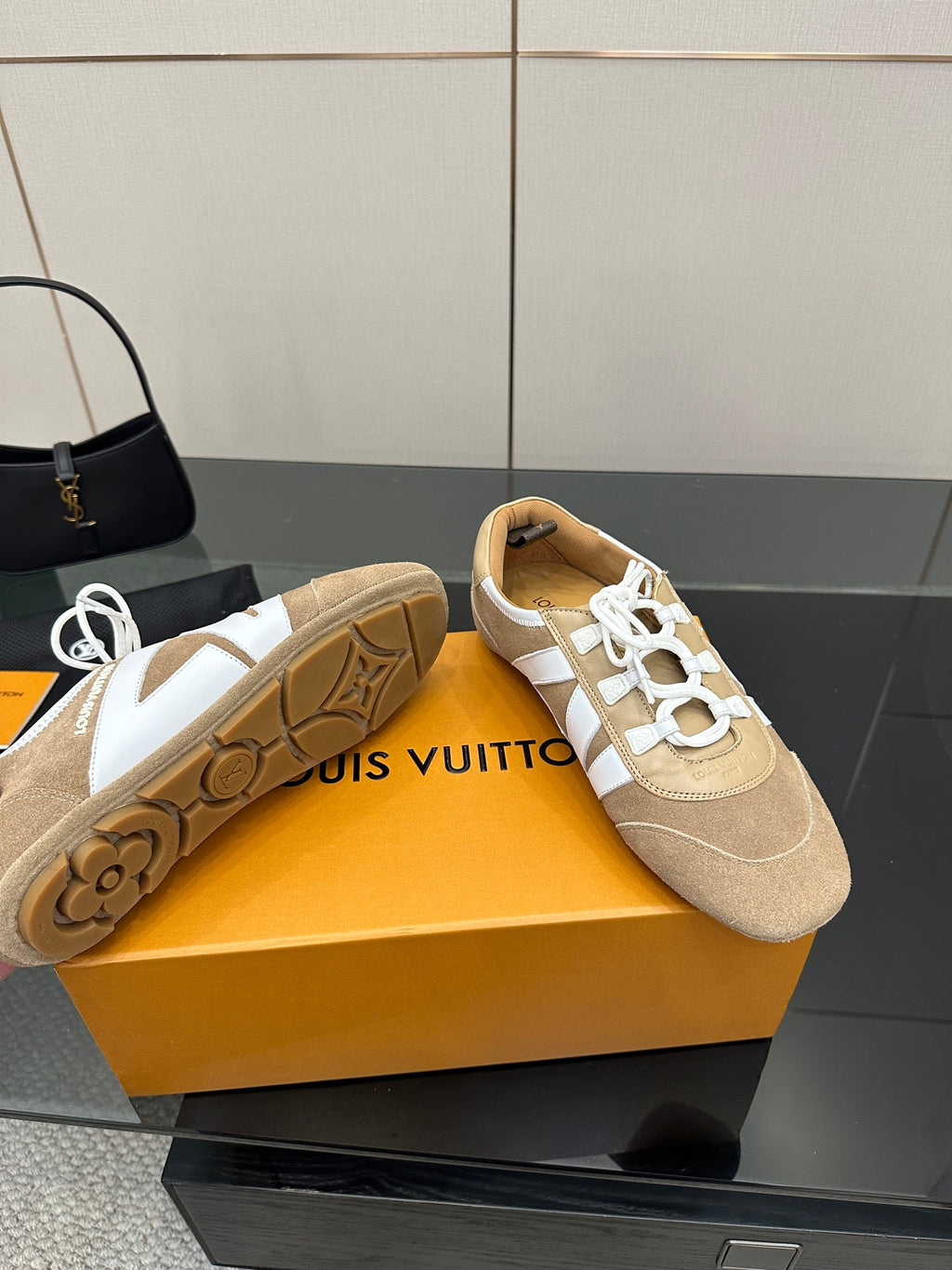 Louis Vuitton women’s beige sneakers with white laces, showing treaded outsole and side panels