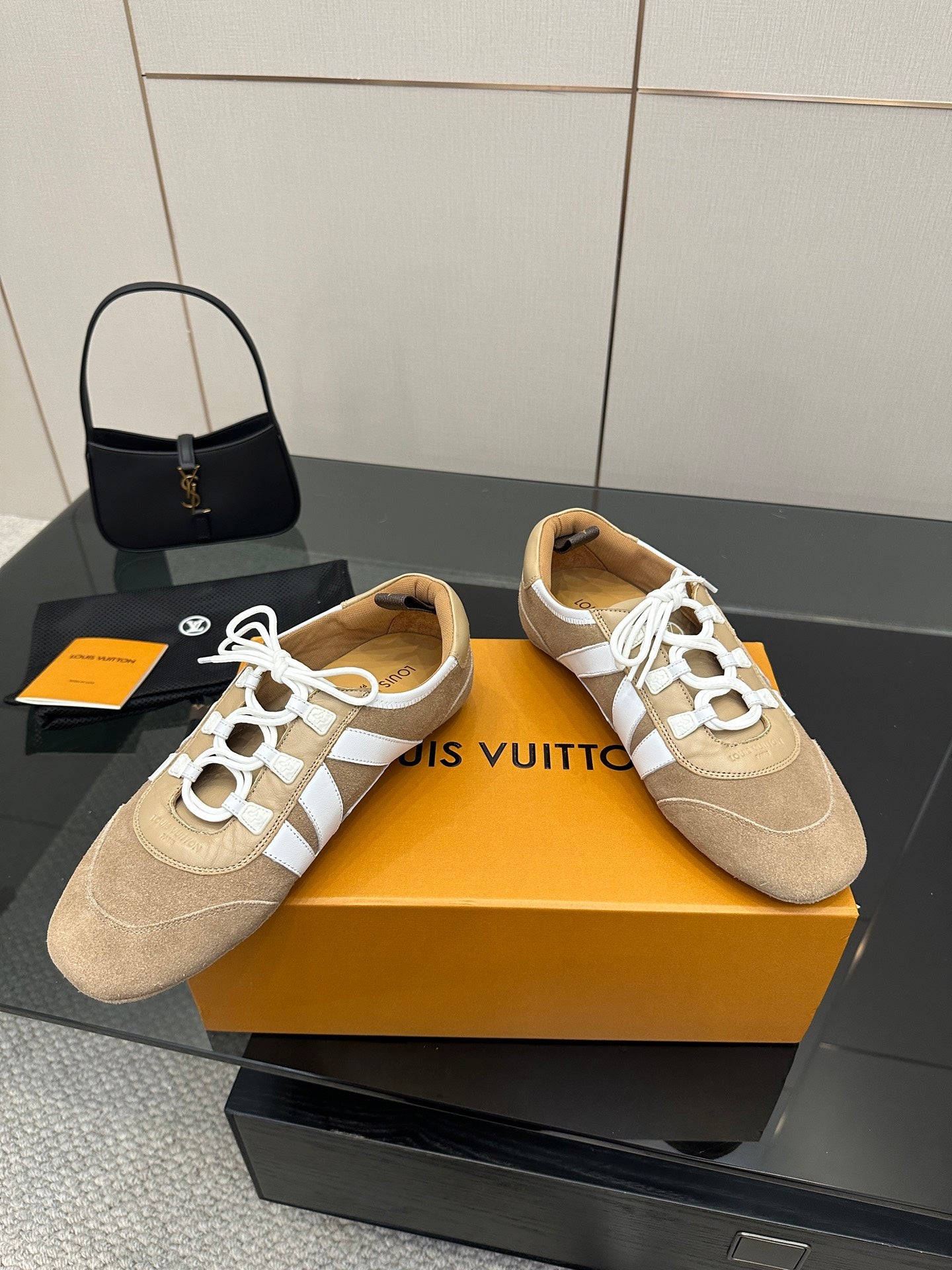Louis Vuitton women’s beige sneakers with white lace-up panels and perforated toe