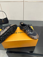 Louis Vuitton lace-up sneakers with treaded sole, monogram upper and black laces