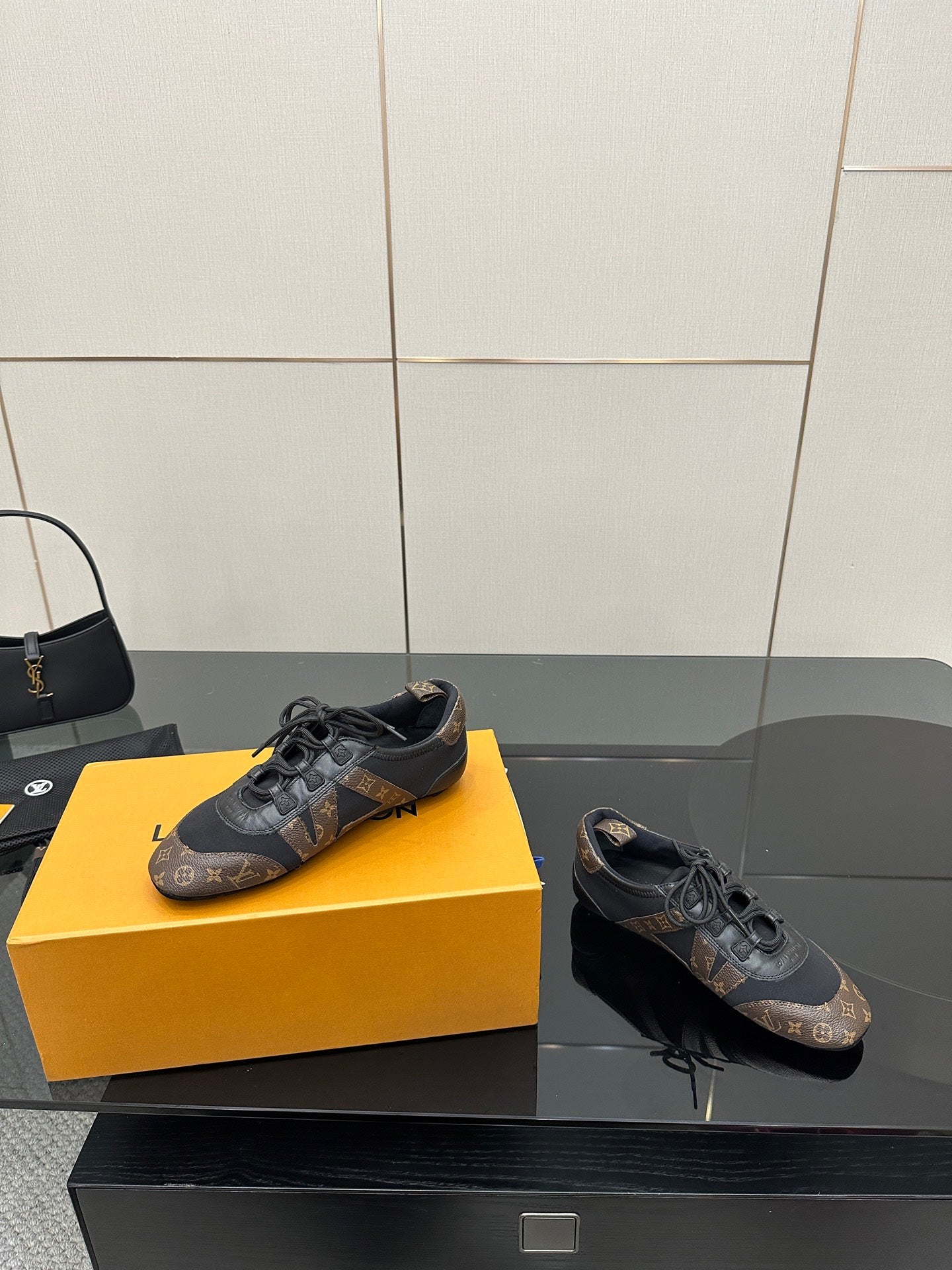 Louis Vuitton lace-up sneakers with black laces, monogram print and low rubber sole