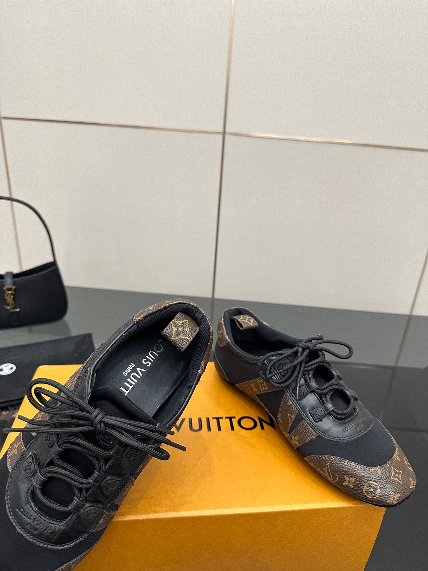 Louis Vuitton lace-up sneakers with cushioned tongue, dark monogram uppers