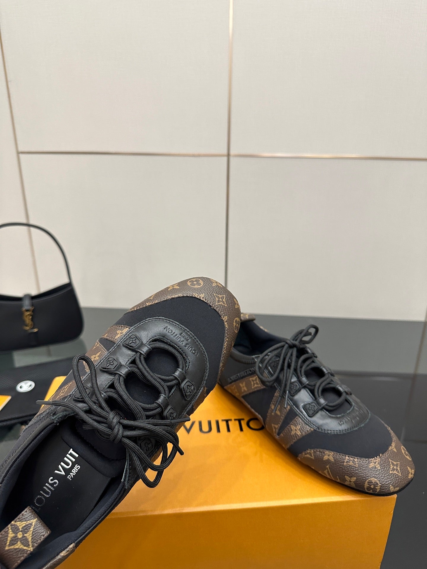 Louis Vuitton lace-up sneakers detail view, monogram side panels and lace-up front