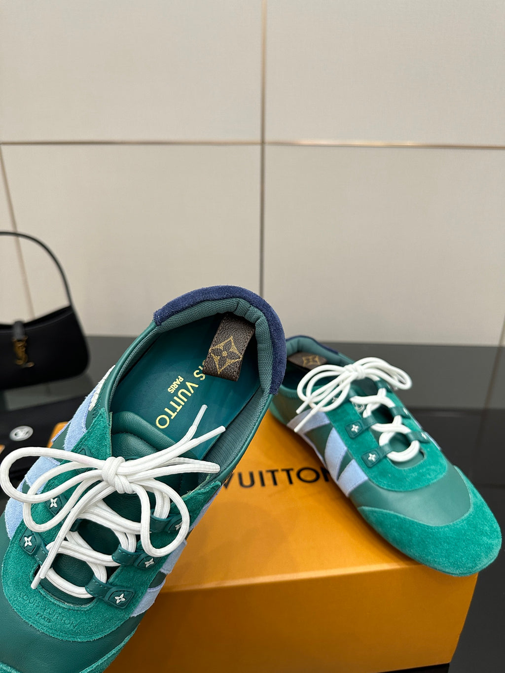Teal low-top sneakers with white laces; interior lining shows printed text