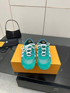 Teal low-top sneakers with white laces and light blue side stripe detail