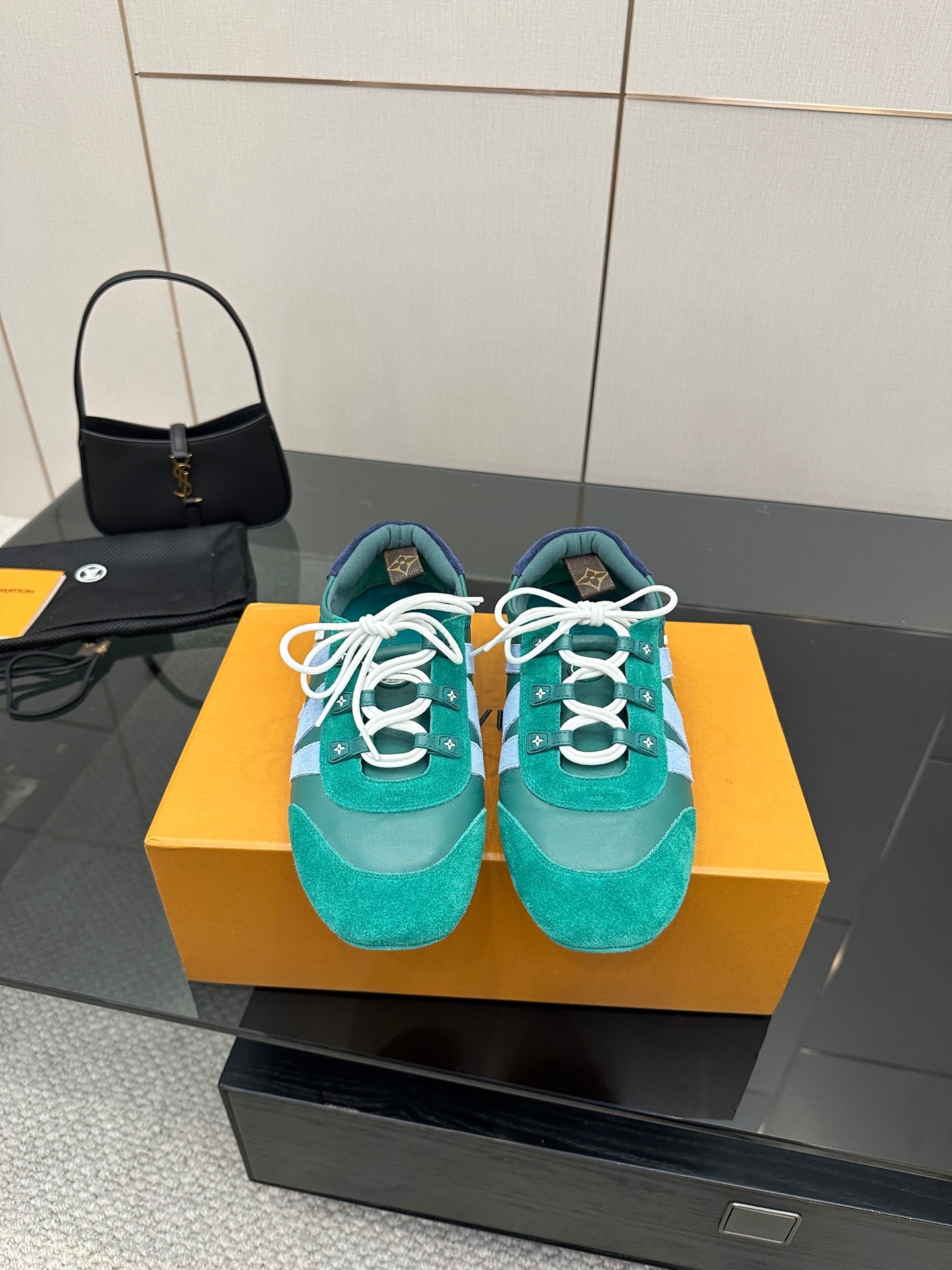 Teal low-top sneakers with white laces and light blue side stripe detail