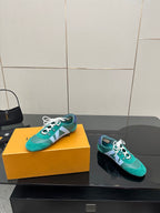 Teal low-top sneakers with white laces, side stripe detail, plus matching dark pair