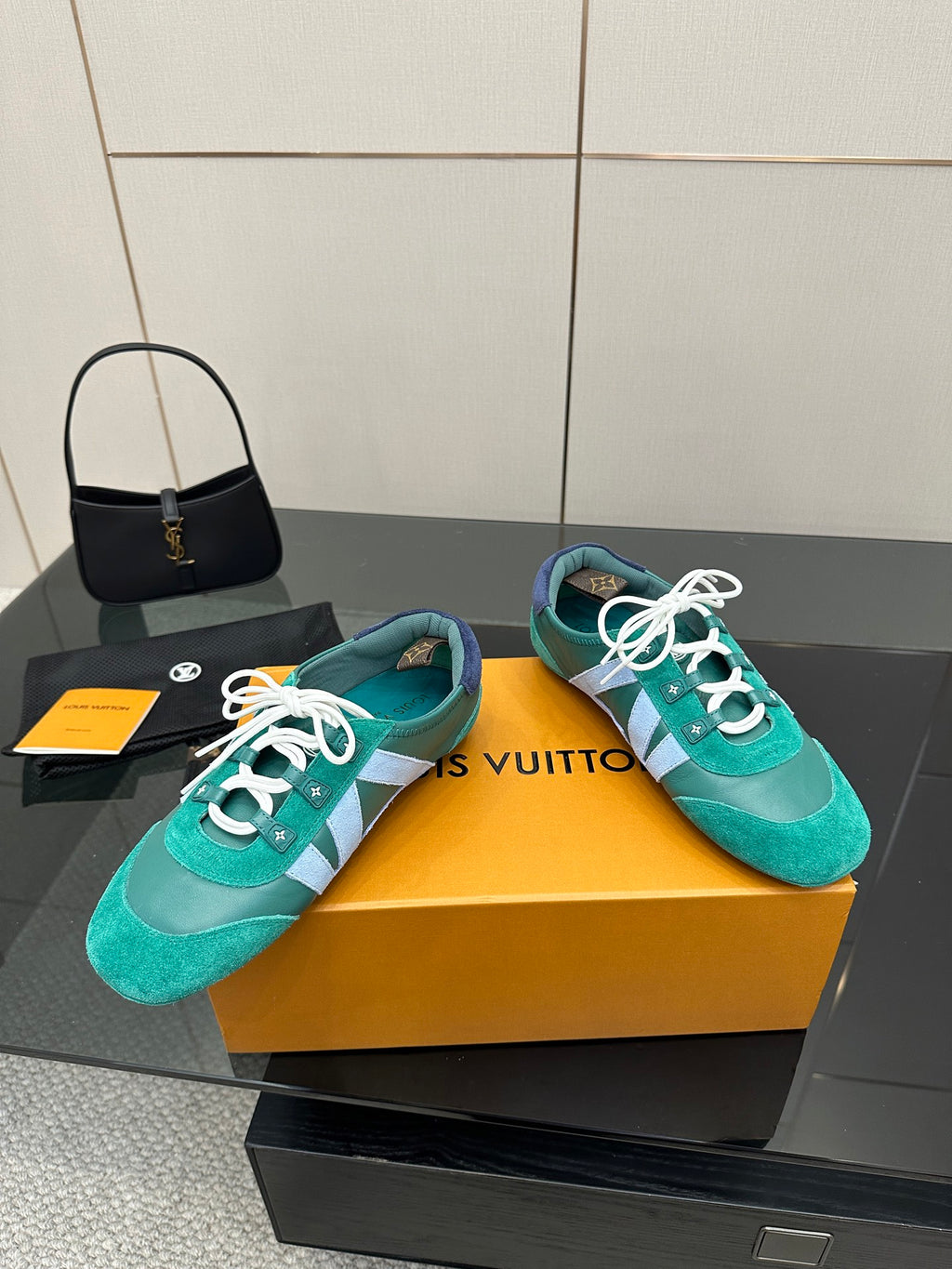 Teal low-top sneakers on box, white laces and light blue side stripe detail