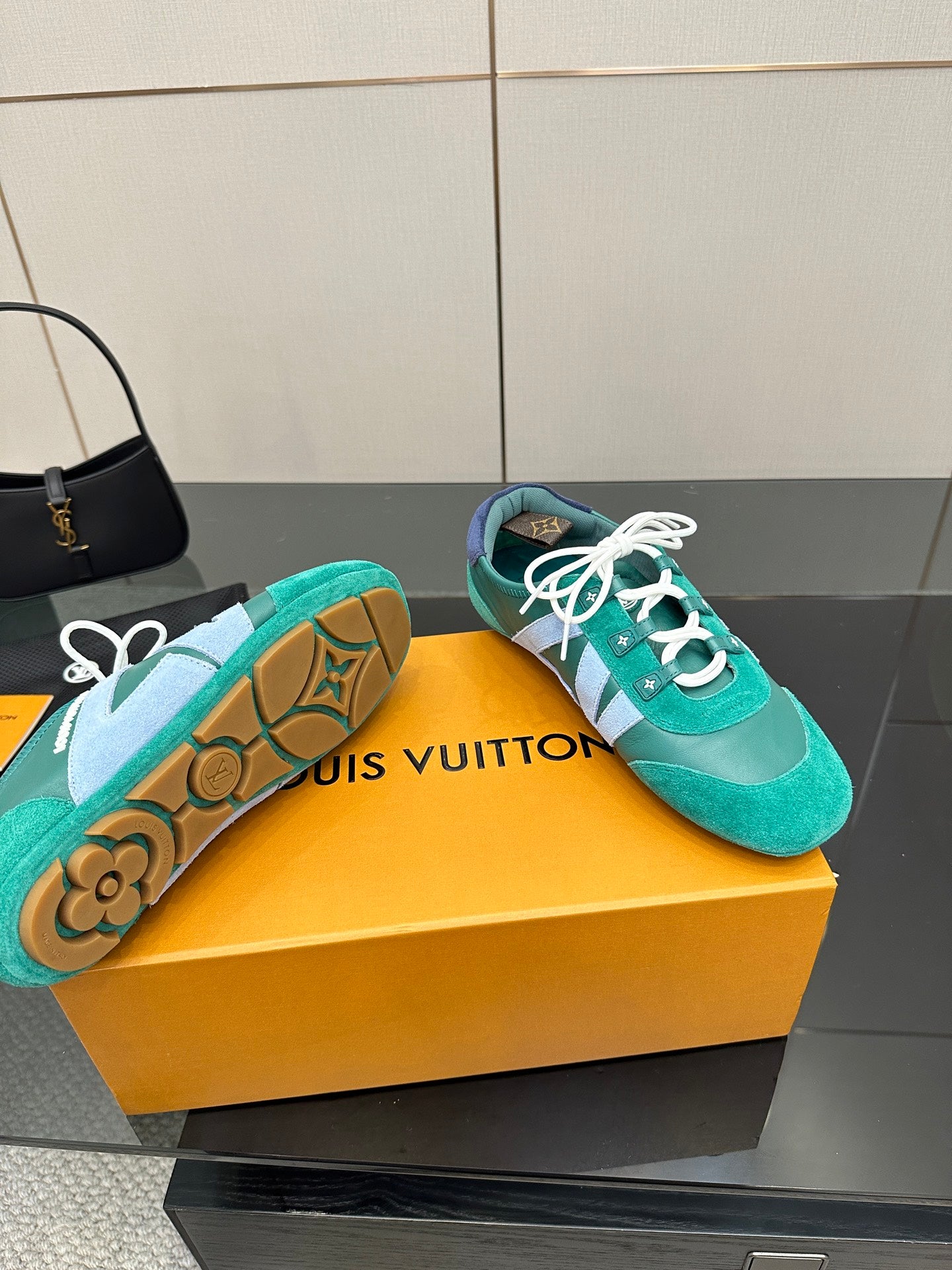 Teal low-top sneakers with white laces and patterned rubber outsole detail