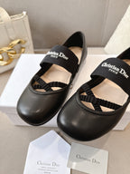 Black women's ballet flats with crisscross strap and logo on top strap.