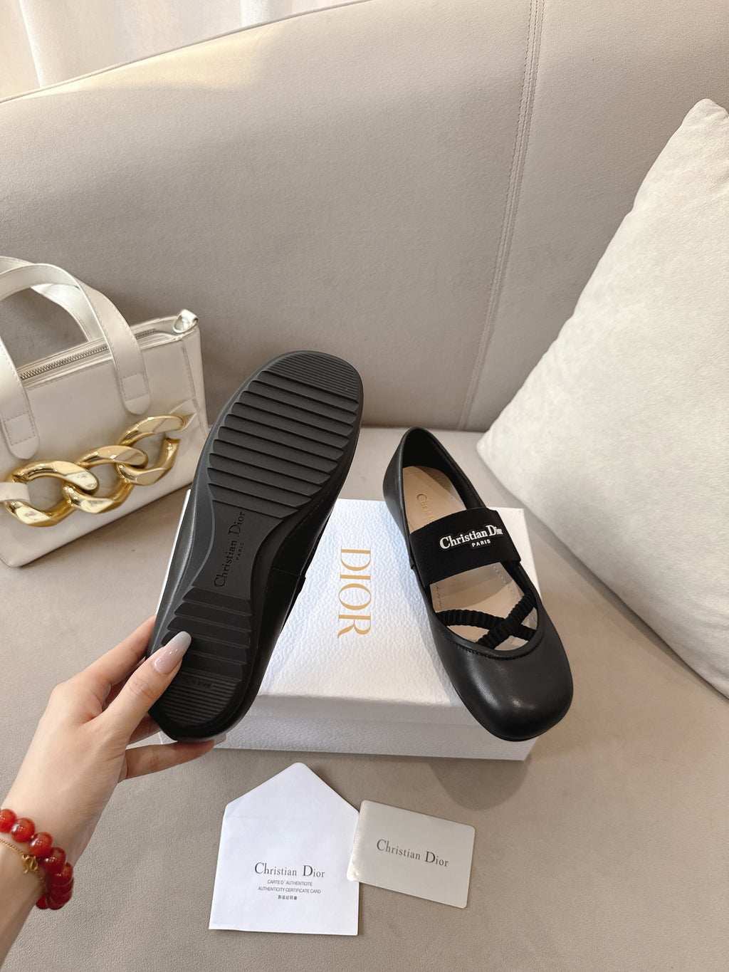 Black women's ballet flats with textured rubber sole and crisscross strap.