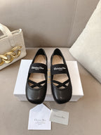 Black women's ballet flats with crisscross strap and logo on the upper.