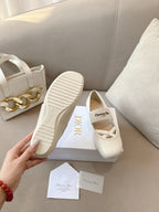Outsole and top view of light cream Dior ballerina flats with rubber tread