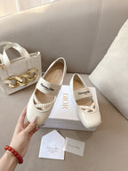 Light cream Dior ballerina flat with logo tag and elastic strap across vamp