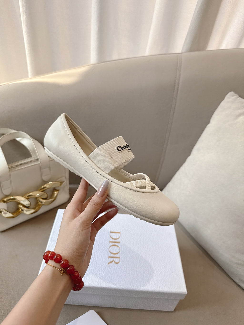 Light cream Dior ballerina flat with elastic strap and logo insole detail